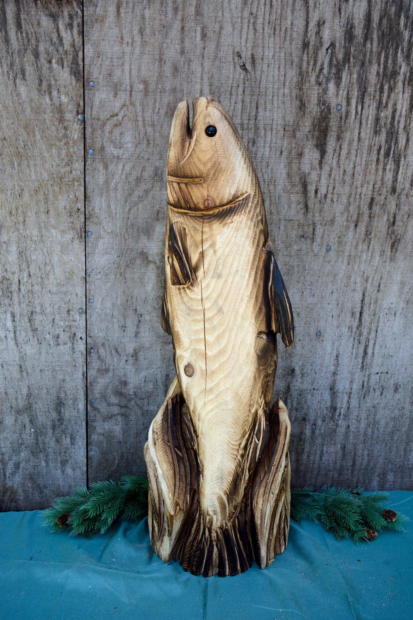 Premium Photo  A carved wooden fish is carved in a wood.